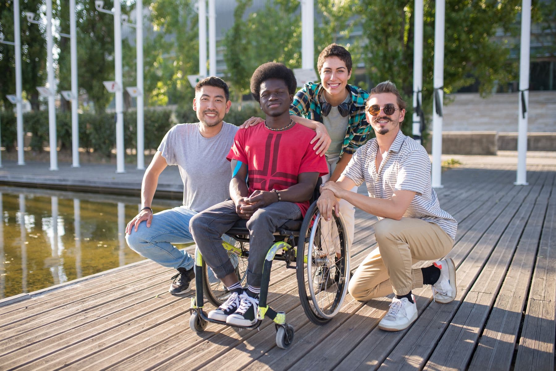 A diverse group of friends, including a wheelchair user, spending time together outdoors