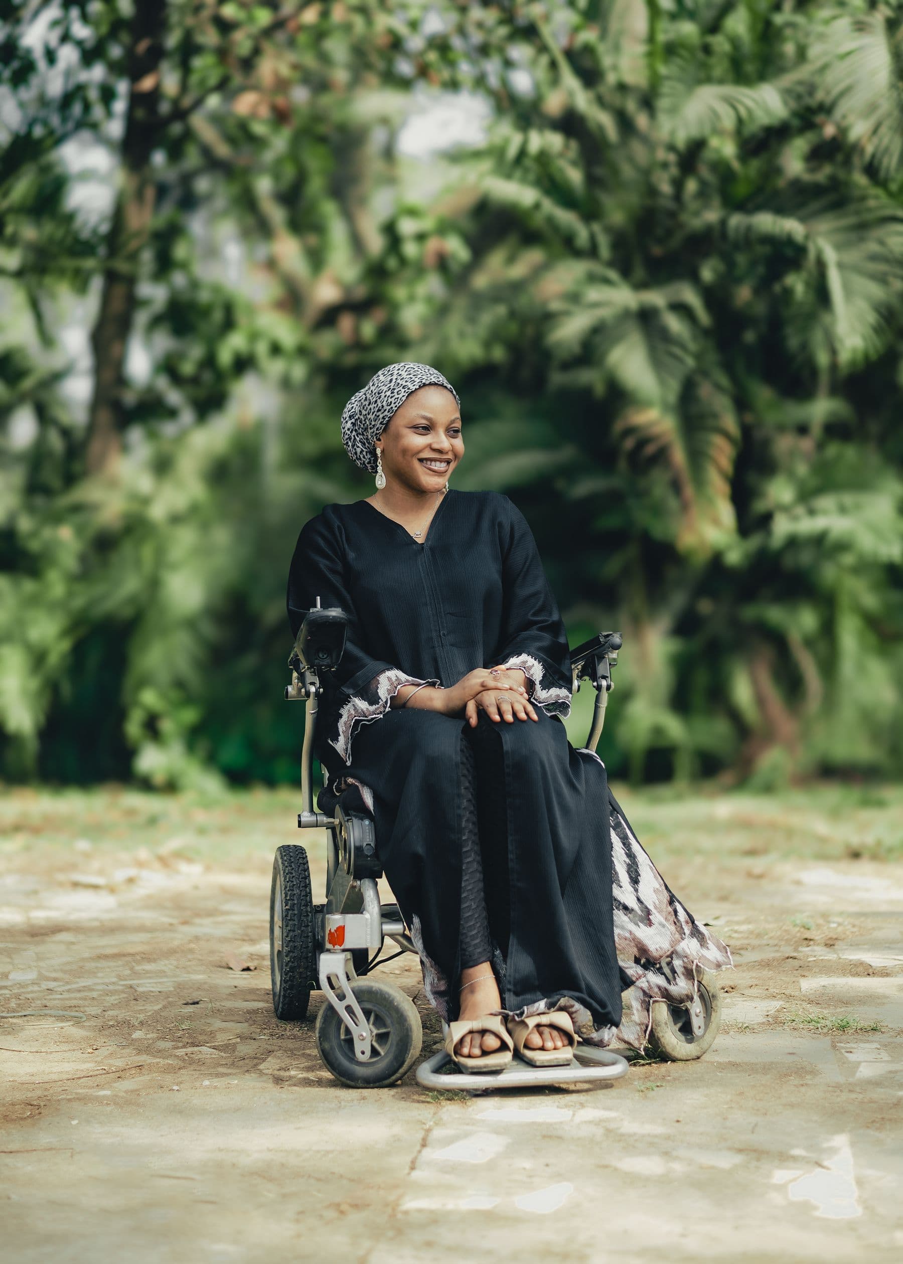 A wheelchair user smiling outdoors